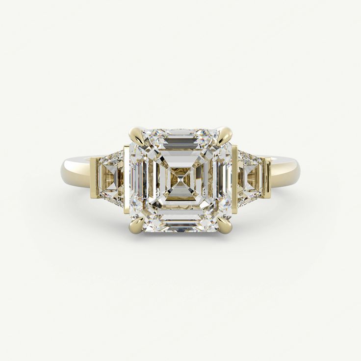 an emerald cut diamond ring with three baguets