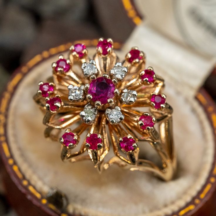 This lovely ruby and diamond cluster ring features a centered, 8-prong set round ruby that is accented with a halo of diamonds and a halo of rubies. The ring is crafted in 10k yellow gold. Ring Design With Stone, Gold Rings Vintage, Gold Ring With Stone, Ruby Jewelry Ring, Diamond Ring Designs, Ruby Ring Designs, Stone Ring Design, Traditional Ring, Antique Gold Rings