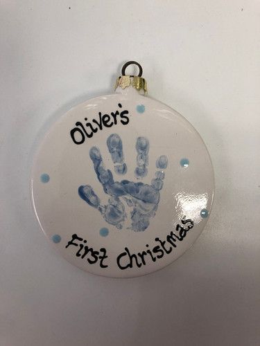 a ceramic ornament with a handprint on it that says, otter's first christmas