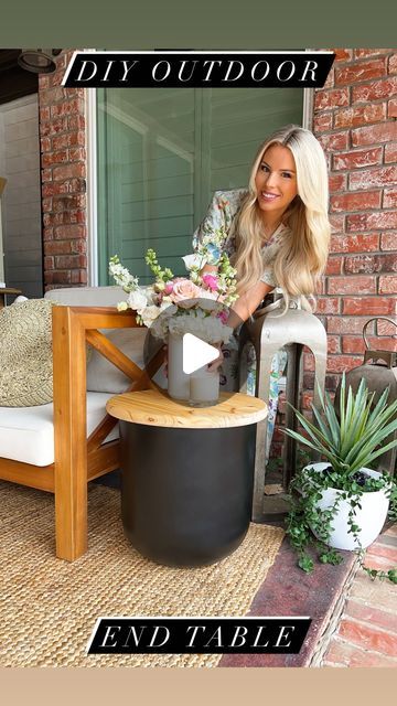 a woman sitting on top of a chair next to a table with flowers in it