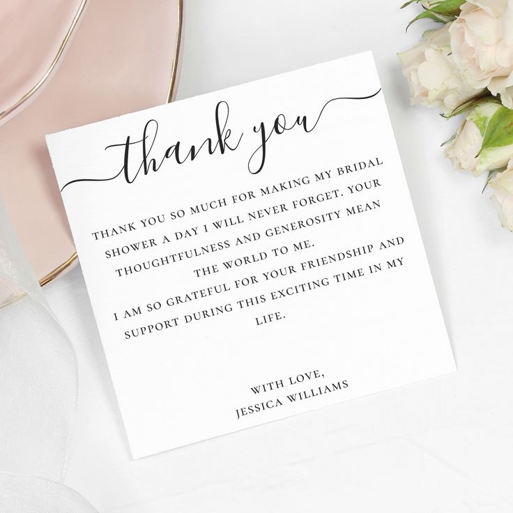 a thank card sitting on top of a table next to flowers and a pink plate