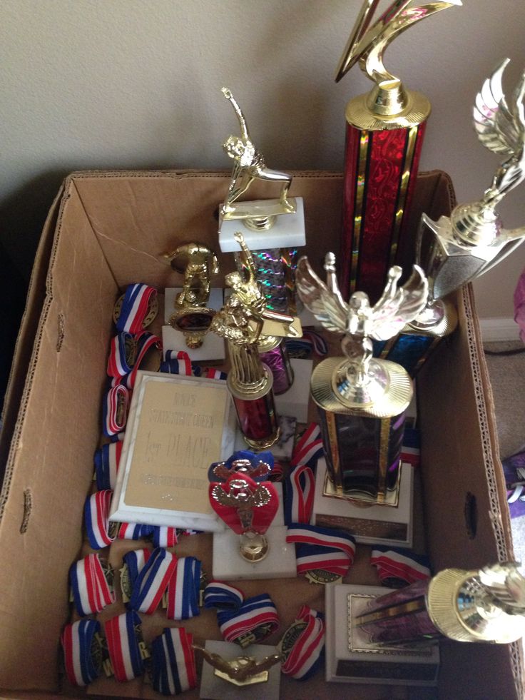 a box filled with lots of trophies and other items sitting on top of a table