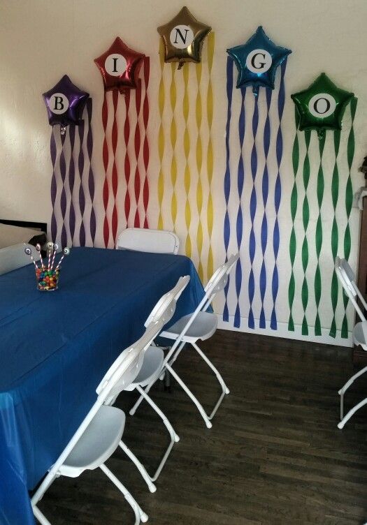 a room decorated with colorful balloons and wall hangings that say n is for one