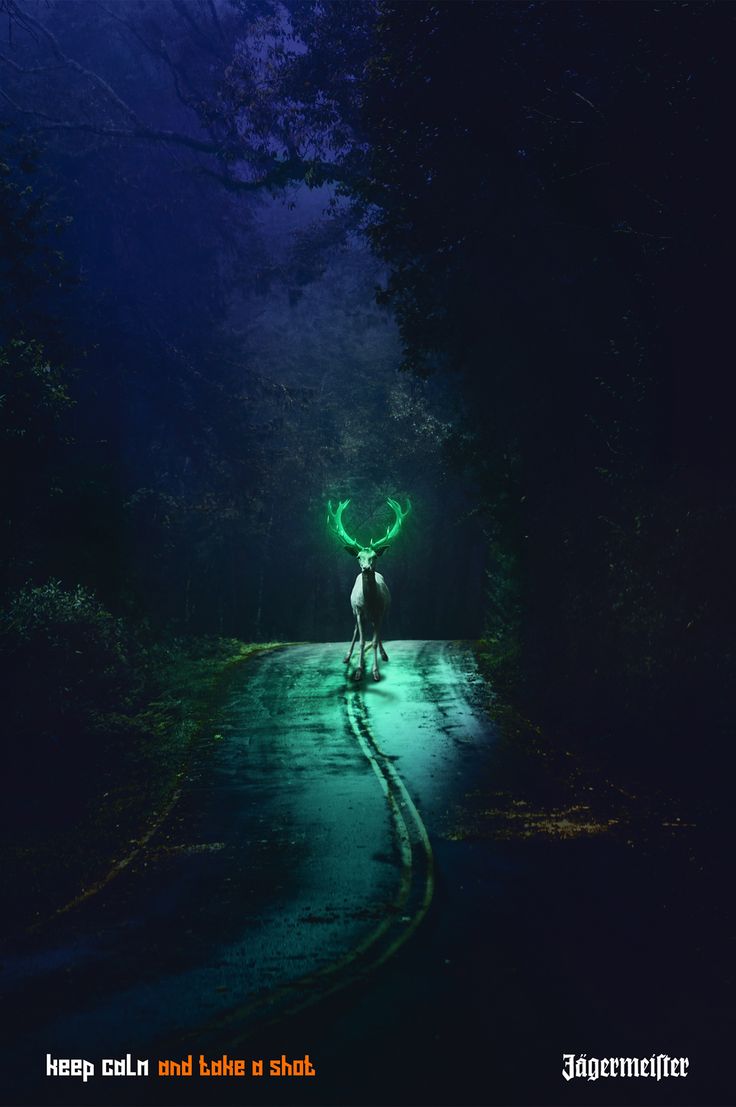 a person standing in the middle of a road at night with green lights on their head