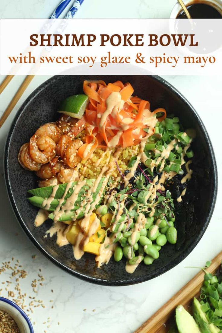 shrimp poke bowl with sweet soy glaze and spicy mayo in a black bowl next to chopsticks