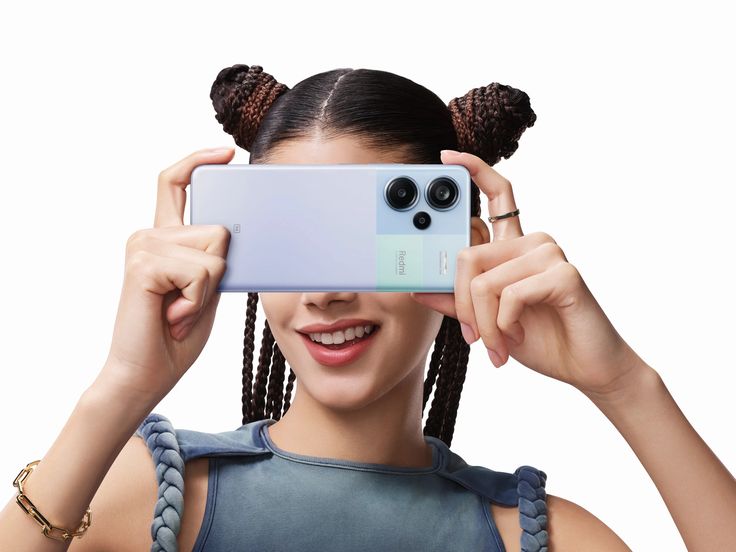 a woman taking a selfie with her cell phone in front of her face and two ponytails on top of her head