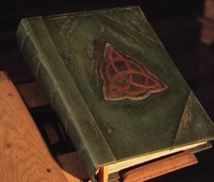 a green book with a red triangle on it sitting on top of a wooden table