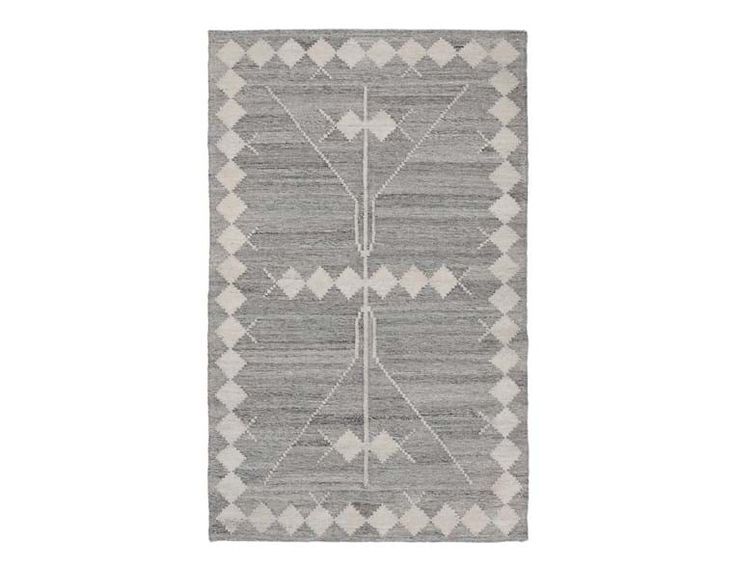 a gray and white rug with geometric designs on the front, in two different colors