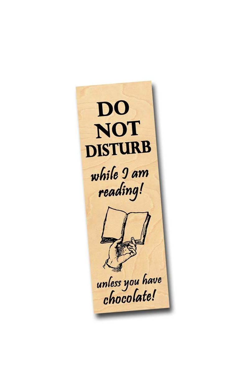 a wooden bookmark that says do not disturb while i am reading unless you have chocolate