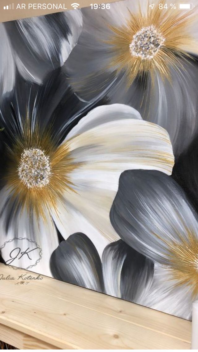 a painting with flowers painted on it in black, white and gold colors is shown