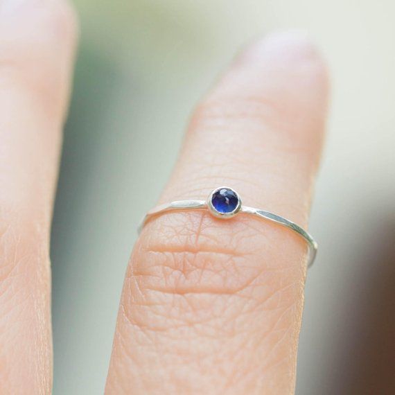 Tiny skinny stackable ring with beautiful deep blue Sapphire stone. It is made with a skinny but sturdy band, which allows you to create mind-blowing stacking sets! The ring is ideal for everyday wear and it will also look amazingly with a festive dress.The ring is 0,8-0,9 mm thick and looks very dainty on the finger. Choose the finish of the stone (smooth cabochon or rose cut) and material for the ring (sterling silver or 9k gold).If you want to change the ring band design or get a custom ring Blue Stackable Midi Rings, Sterling Silver Birthstone Ring For Everyday, Everyday Sterling Silver Birthstone Ring With Gemstone, Adjustable Birthstone Midi Rings For Everyday Wear, Everyday Adjustable Birthstone Midi Rings, Adjustable Everyday Birthstone Midi Rings, Everyday Midi Rings With Birthstone In Round Band, Everyday Birthstone Midi Rings With Round Band, Minimalist Sapphire Ring With Bezel Setting For Everyday