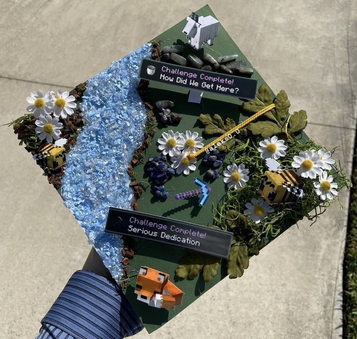 a graduation cap decorated with flowers, rocks and other things that are on top of it