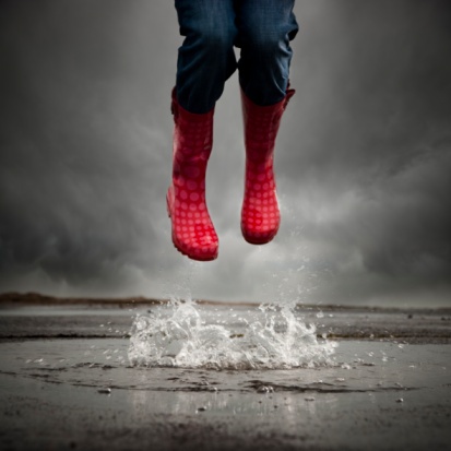 a person in red boots jumping into the water