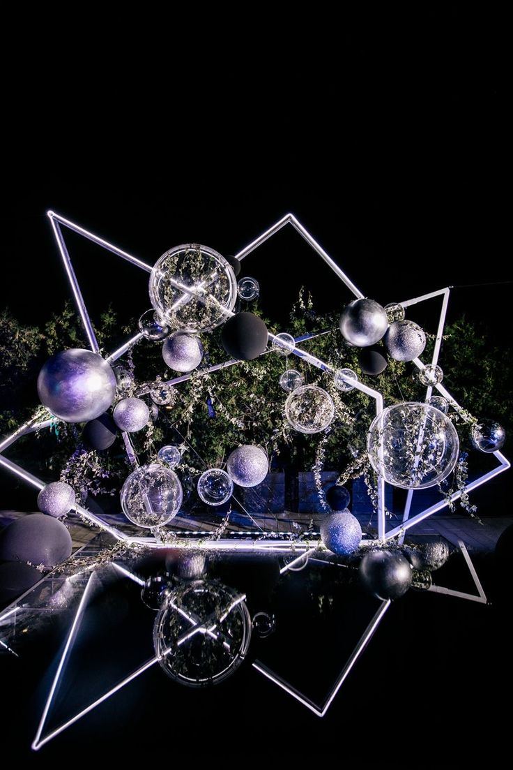 an artistic sculpture made out of glass balls and other objects in the shape of a star