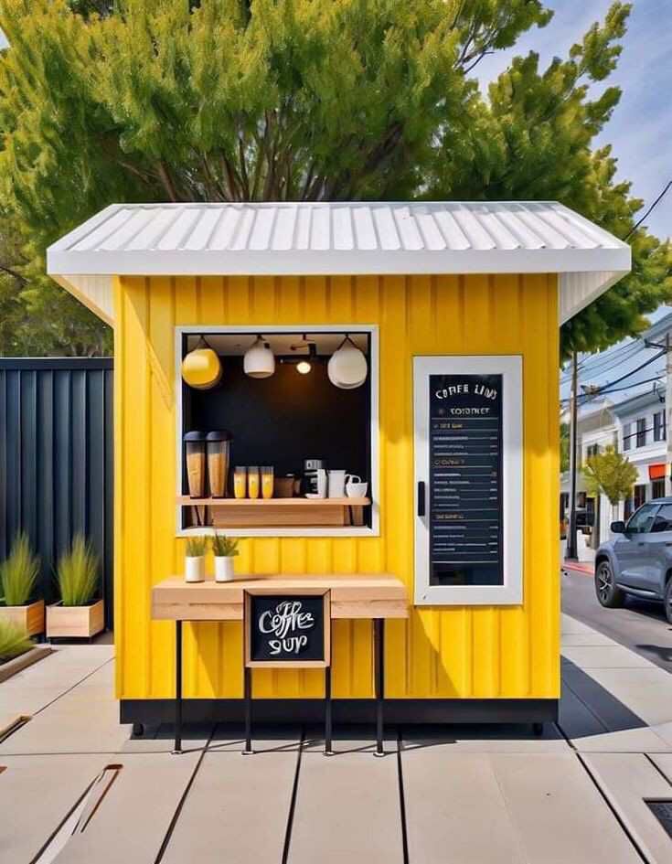 a small yellow coffee shop on the sidewalk