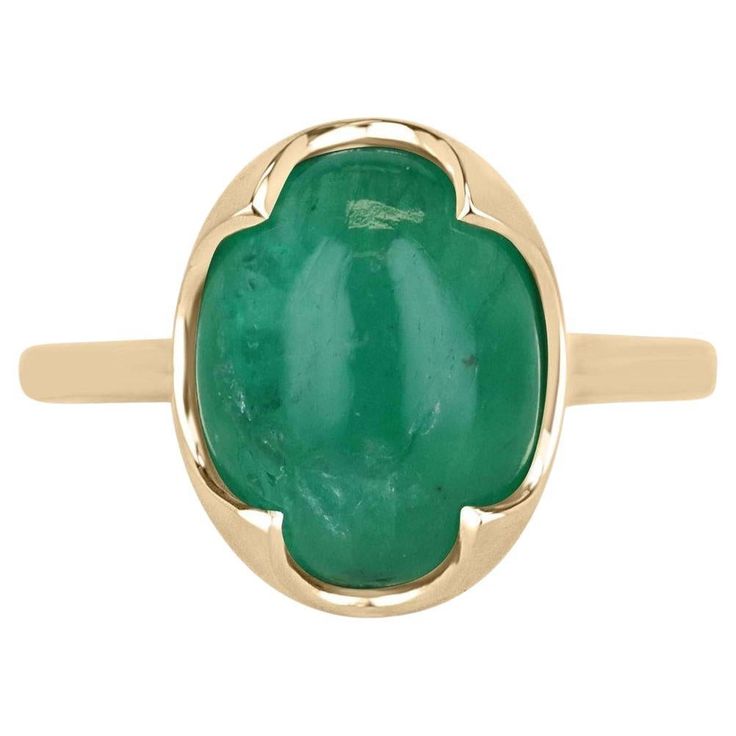 Elevate your style with our mesmerizing emerald cabochon solitaire ring, boasting a stunning 4.29-carat oval cabochon cut emerald sourced from the verdant lands of Zambia, radiating a medium dark green hue with translucent clarity. Embraced by a uniquely crafted four-prong setting in luxurious 14k yellow gold, this ring exudes an irresistible fusion of elegance and eccentricity, making it a standout piece for any occasion. Setting Style: Prong-Solitaire Setting Material: 14K Yellow Gold Setting Weight: 3.0 Grams Main Stone: Emerald Cut: Cabochon Shape: Oval Approx Weight: 4.29-Carats Clarity: Translucent Color: Green Luster: Good Treatments: Natural, Oiling Origin: Zambian Estimated Retail Value: $7,590.00 USD A certificate of appraisal is provided upon purchase. Emerald Solitaire Ring, Emerald Cabochon, Emerald Cut Engagement, Solitaire Setting, Modern Engagement Rings, Right Hand Rings, Colombian Emeralds, Cabochon Ring, Yellow Gold Setting