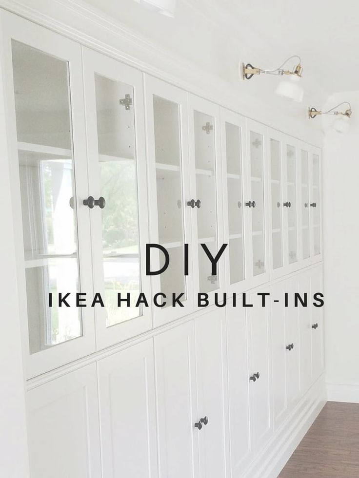 an empty room with white cabinets and wood flooring in the background is text that reads diy ikea hack built - ins