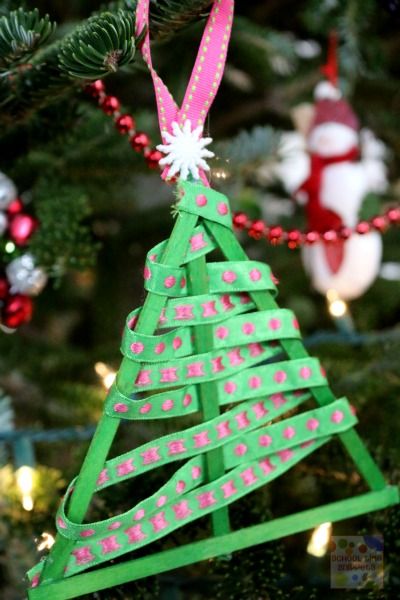 a christmas tree ornament made out of strips of green paper with pink and white polka dots