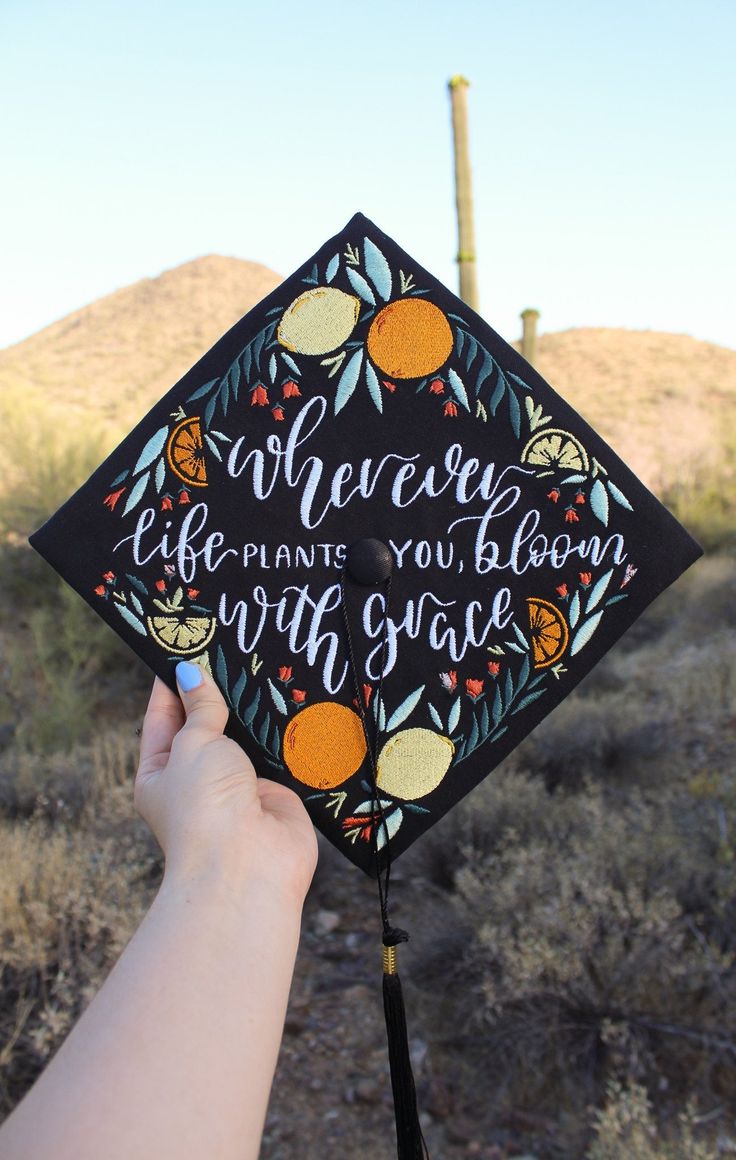 someone is holding up a graduation cap that says, wherever life plants you bloom with space