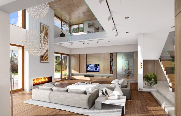 a modern living room with wood flooring and white couches in front of a fireplace