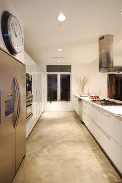 a kitchen with a large clock on the wall