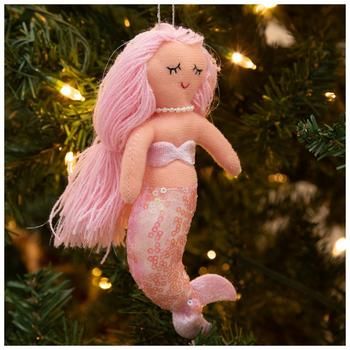 a pink mermaid ornament hanging from a christmas tree