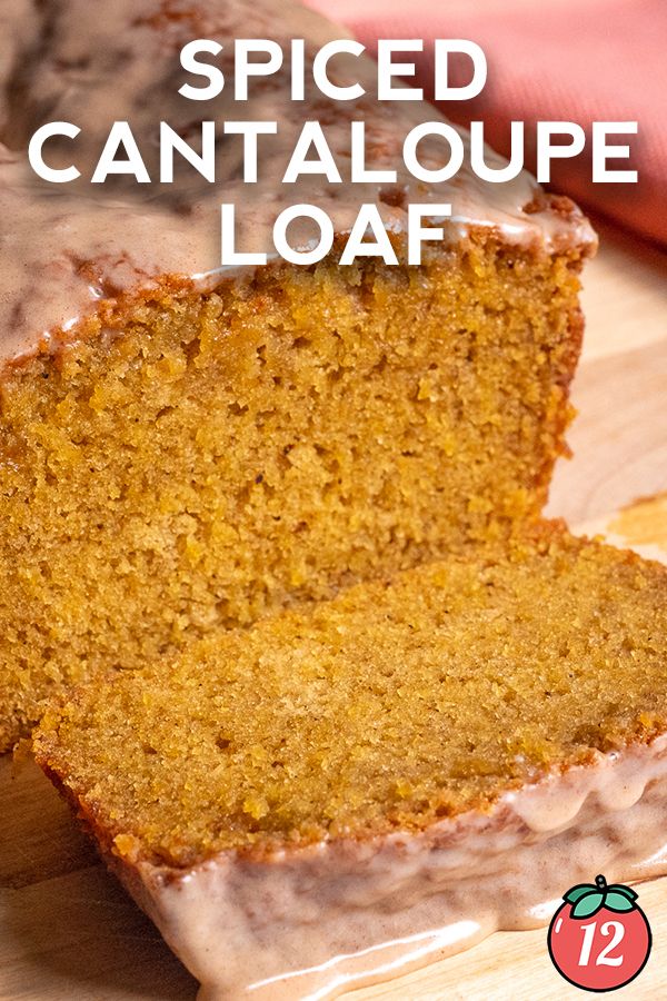 a loaf of spiced cantaloupe loaf on a cutting board with text overlay