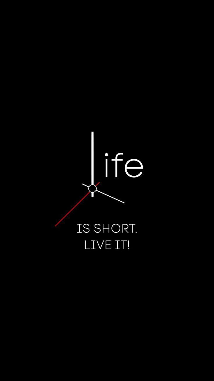 a clock with the words life is short, live it written in white on a black background