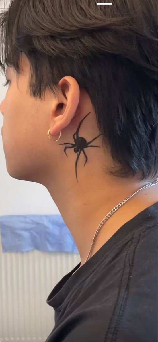 a woman with a spider tattoo on her neck