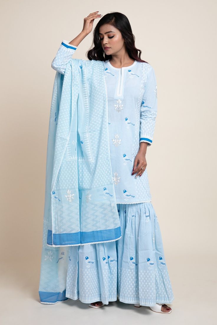 Aqua blue cotton cambric printed kurta in floral foil and bird motifs. Paired with a printed gharara and dupatta.
Component: 3
Pattern: Printed
Type Of Work: Bird, Floral, Geometric, Foil print
Neckline: Round
Sleeve Type: Three quarter
Fabric: Cotton cambric, Mulmul
Color: Blue
Other Details: 
Lace work detail
Side tassel gharara
Occasion: Mehendi - Aza Fashions Block Print Mulmul Sharara With Straight Kurta, Bollywood Style Cotton Sharara With Block Print, Eid Block Print Mulmul Sharara, Eid Mulmul Sharara With Block Print, Cotton Block Print Sharara For Festivals, Cotton Sharara With Block Print For Festivals, Blue Cotton Salwar Kameez With Gota Work, Cotton Block Print Palazzo Set For Wedding, Festival Cotton Sharara With Block Print