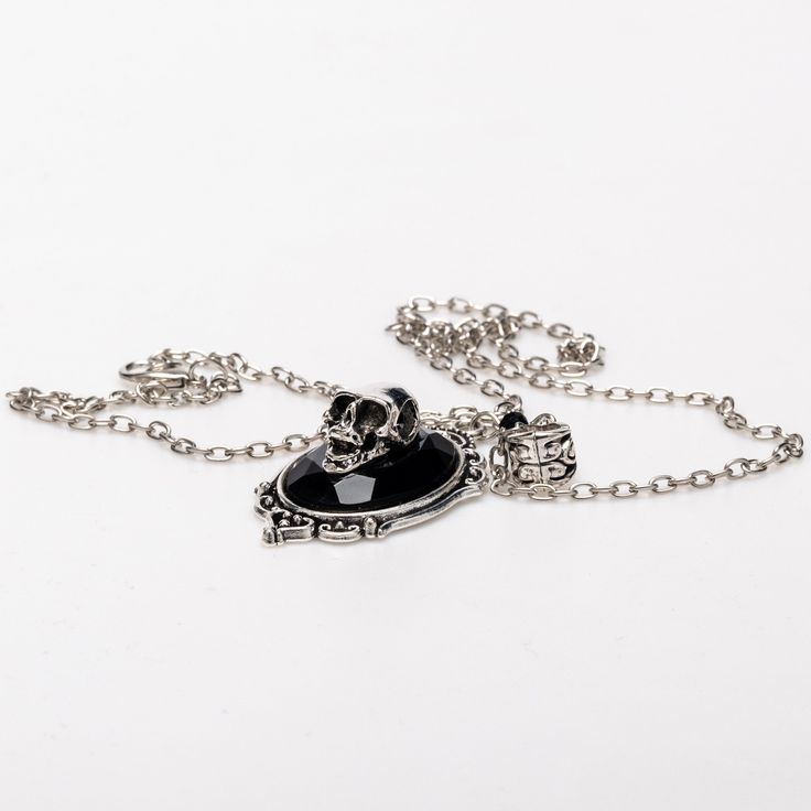 Crafted from stained alloy stainless steel, our Victorian skull necklace is a striking piece. Measuring 20 inches in length, it features a 1 by 1.5-inch skull pendant, perfect for adding a touch of gothic elegance to any Gothic Black Alloy Necklaces, Black Gothic Alloy Necklaces, Gothic Silver Stainless Steel Necklace, Punk Style Engraved Metal Jewelry, Punk Style Metal Necklace With Skull Print, Punk Stainless Steel Pendant Jewelry, Punk Metal Necklace With Skull Print, Engraved Punk Style Metal Jewelry, Engraved Metal Punk Jewelry