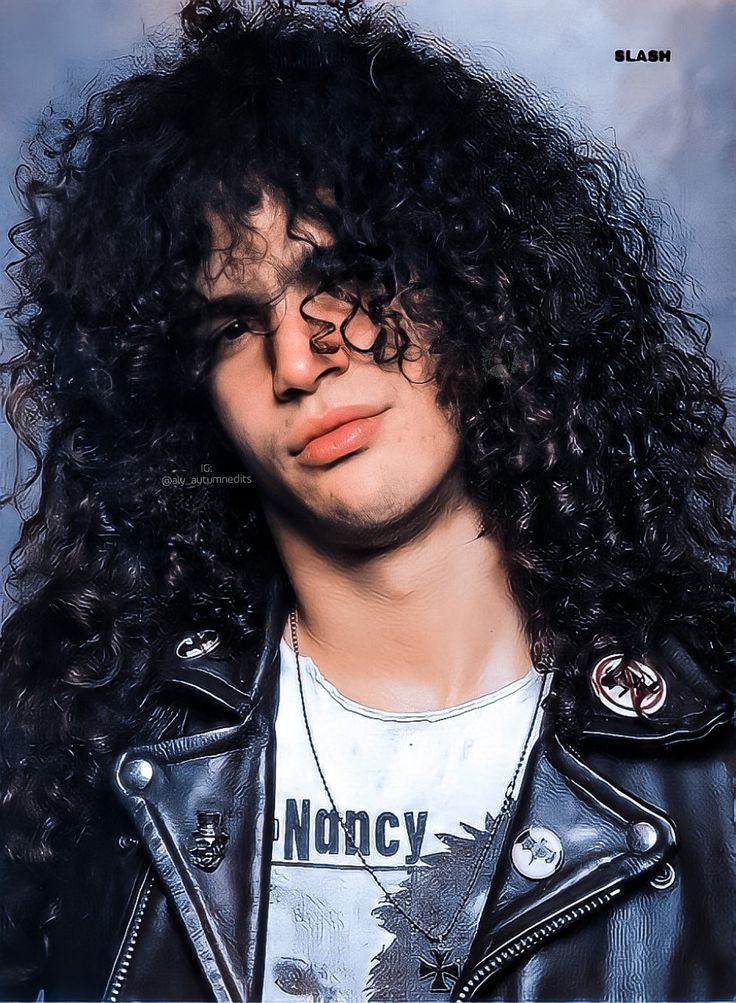 a man with long curly hair wearing a leather jacket