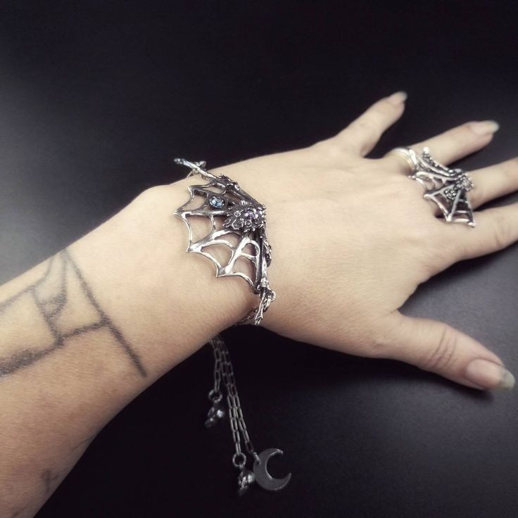 "Lead-free pewter cast spider & spiderweb bracelets with adjustable slider. Moon and skull charms Black, Gray, or Amethyst AB crystals Web 1\" x 2.5\" Spider 1.75\" Fits up to 9\" wrist. Message me if you need longer. All pieces are made-to-order despite the \"in stock\" number in the listing. Time frame varies from piece to piece so please message us if you need something by a certain date and we will do our best. A portion of our profits will be regularly donated to organizations fighting Symbolic Metal Jewelry For Halloween, Mystical Adjustable Jewelry For Halloween, Adjustable Mystical Jewelry For Halloween, Adjustable Metal Body Jewelry For Halloween, Punk Alloy Jewelry For Halloween, Gothic Adjustable Body Jewelry For Halloween, Halloween Silver Body Jewelry Gift, Adjustable Nickel Free Silver Body Jewelry, Adjustable Gothic Silver Jewelry