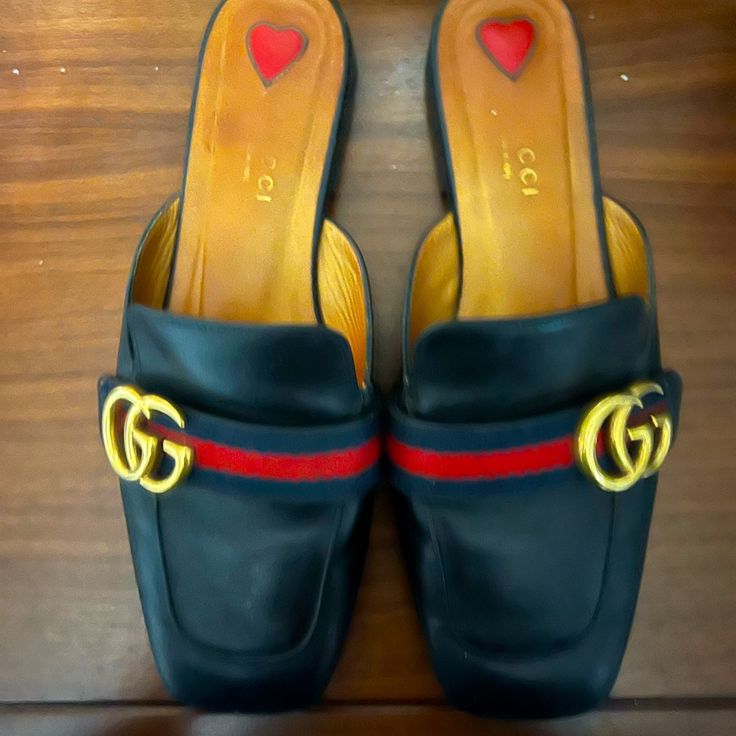 Black Classic Authentic Gucci Slippers In Size 37.5 . Used With Normal Wear. Original Box And Dust Bag Included. Gucci Leather Mules For Evening, Gucci Designer Mules For Formal Occasions, Designer Gucci Mules For Formal Occasions, Designer Flat Mules, Designer Gucci Mules With Branded Heel Counter, Designer Black Closed Toe Mules, Gucci House Slippers, Gucci Designer Slip-on Heels, Luxury Black Flat Heel Mules