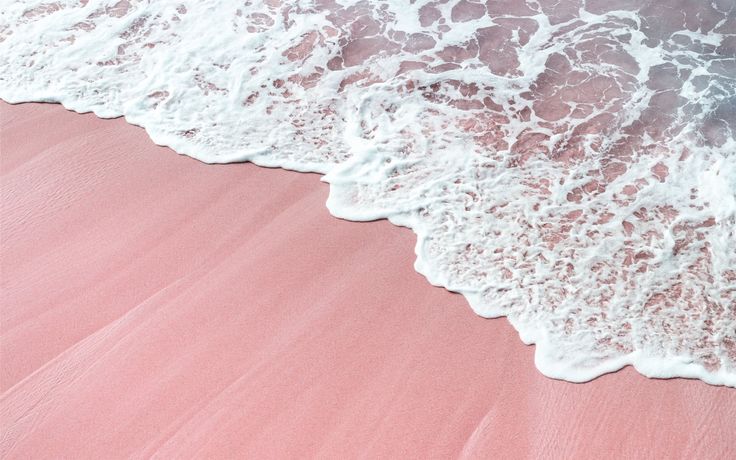 the water is pink and white at the beach