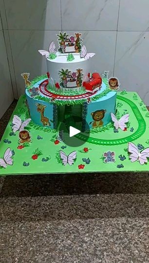 a green table topped with a cake covered in animals