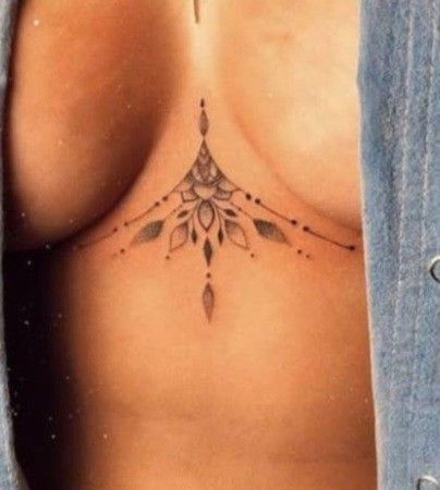 a woman with a tattoo on her chest is looking down at the viewer's stomach