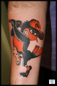 a man with a baseball tattoo on his arm