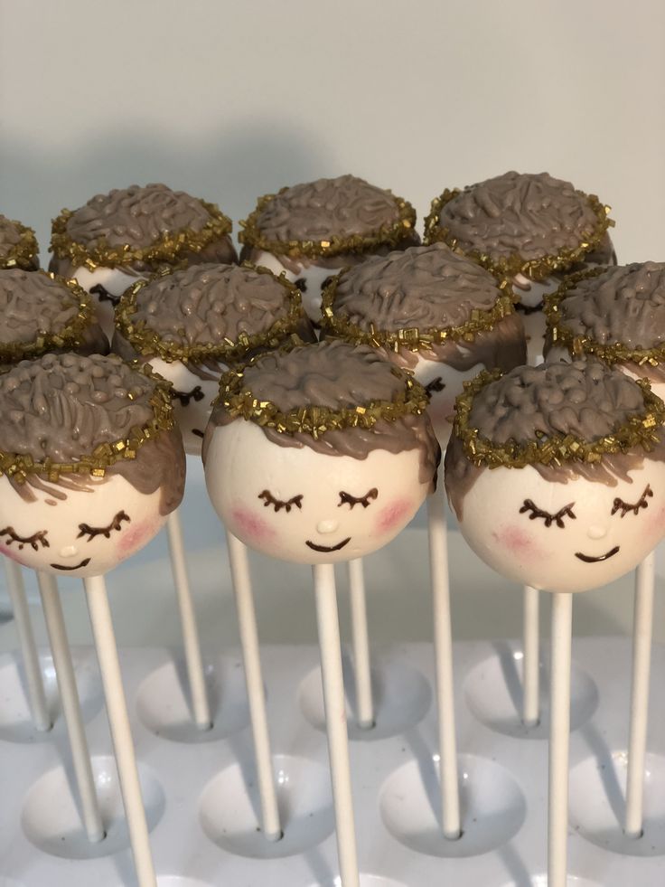 chocolate cake pops with sprinkles on them are arranged in the shape of faces