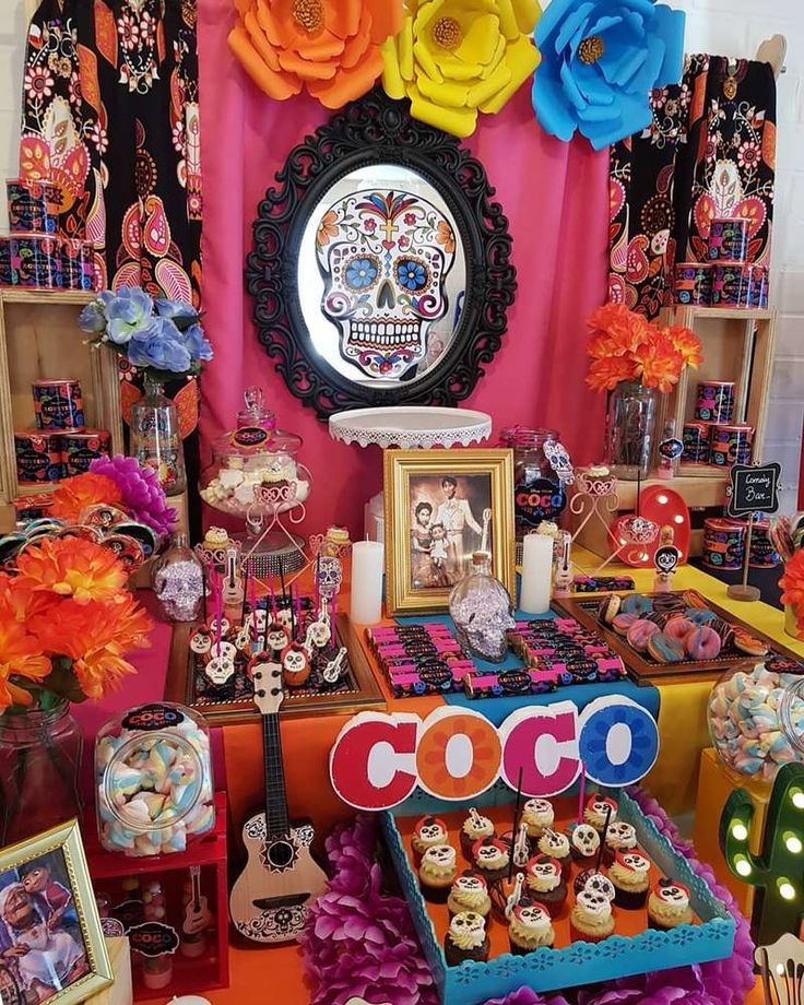 a table topped with lots of cupcakes and cakes