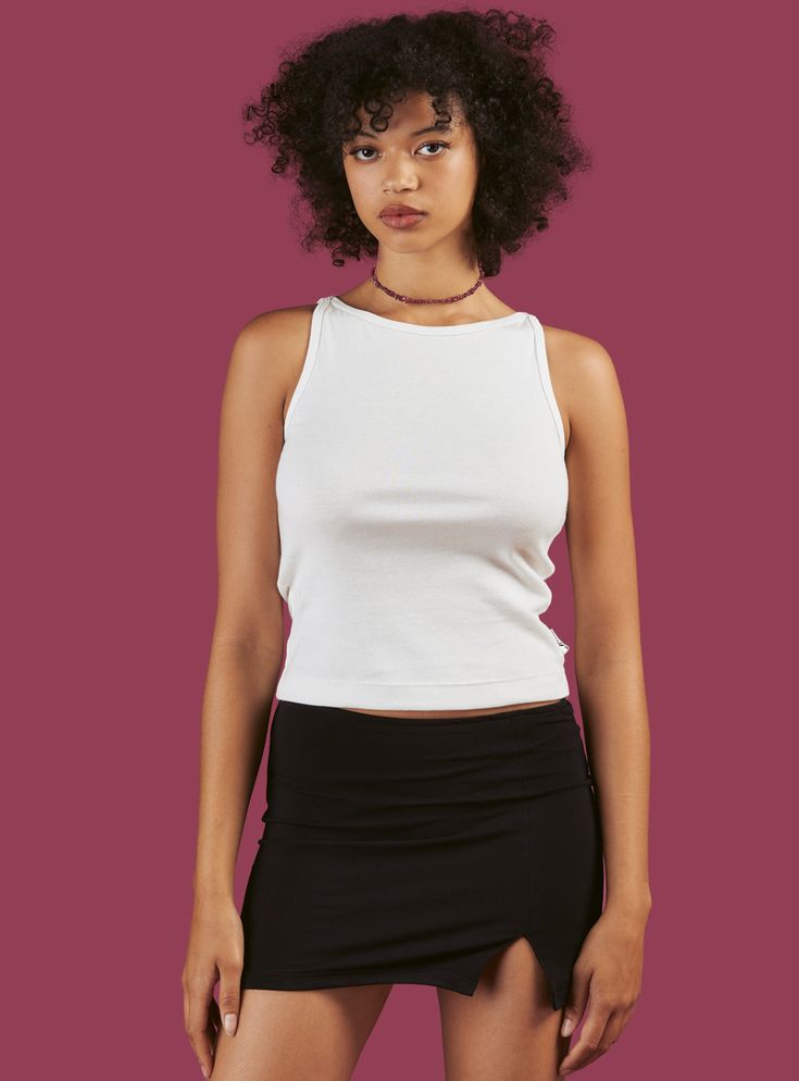 3-pack of our all-new custom cut and sew Wide tank top. Perfect basic to go with any look. Comes with one true black, one vintage white, and one heather grey tank. Has UNIF flag tag at bottom side hem. Fit is true to size. The model is 5'10" and wearing a size S. Black and White Tanks: 100% Cotton; Grey Tank: 50% Polyester, 38% Cotton, 12% Spandex Made in Los Angeles SKU: UWT-1552 White Tanks, Flag Tag, Shot List, Gray Tank, Off Black, White Tank, Black Grey, White Vintage, Basic Tank Top