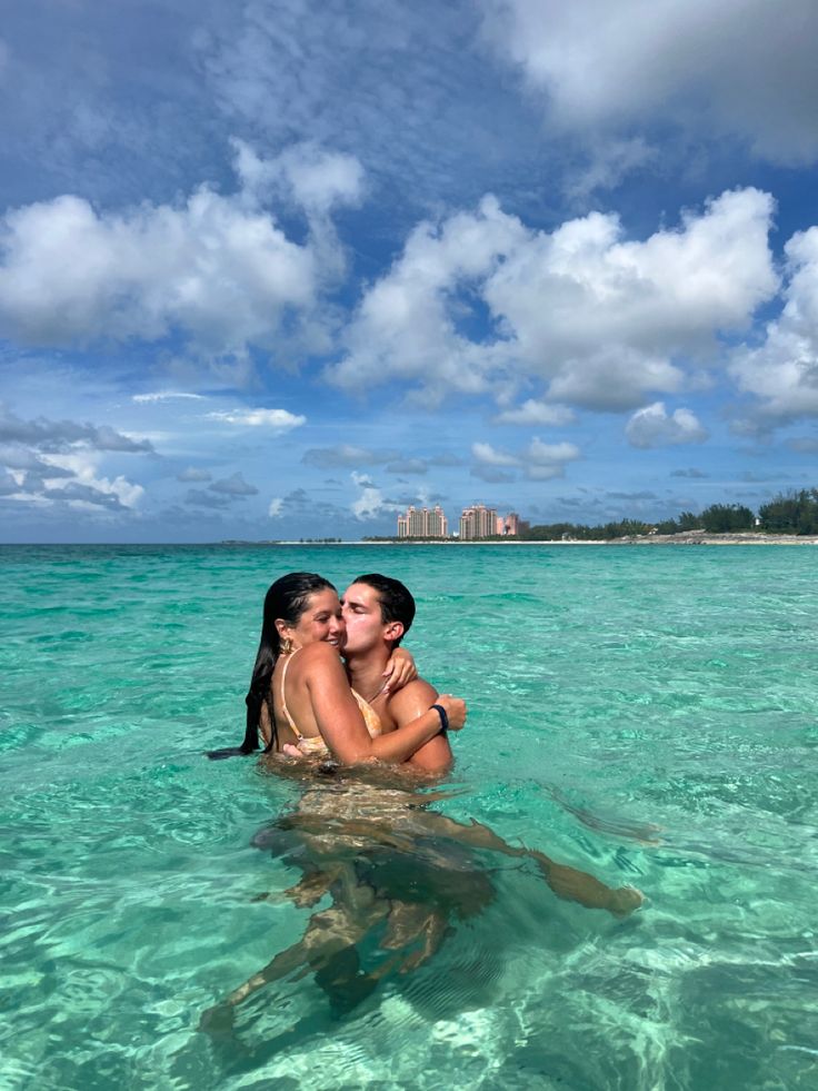 two people in the ocean kissing each other