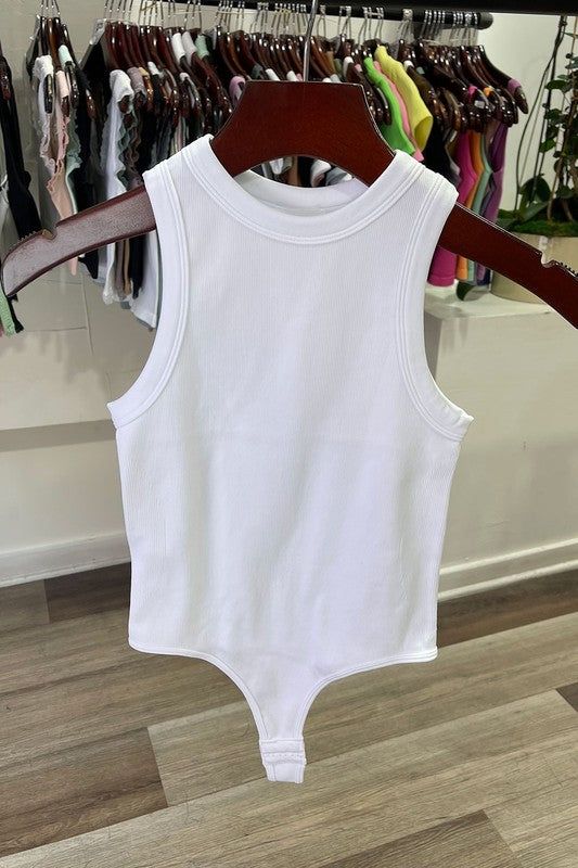 The White Tank Rib Bodysuit is perfect for a night out. Crafted with a ribbed fabric and cut for a body-hugging fit, this bodysuit will keep you looking stylish and feeling comfortable all night long. The tank ribbed design fits snug to your figure, making a sleek statement. Complete your look with a pair of jeans or a skirt for a night of fun. Fabric & fit: 92% nylon 8% spandex Model is wearing size Small. Seamless Bodysuit For Night Out In Spring, Ribbed Bodycon Tops For Summer, Summer Ribbed Bodycon Tops, Casual Ribbed High-stretch Bodysuit, Ribbed Bodycon Summer Tops, Fitted White Tank Bodysuit, White Fitted Tank Bodysuit, Ribbed Bodycon Tank Top For Summer, Casual Ribbed Bodysuit For Night Out