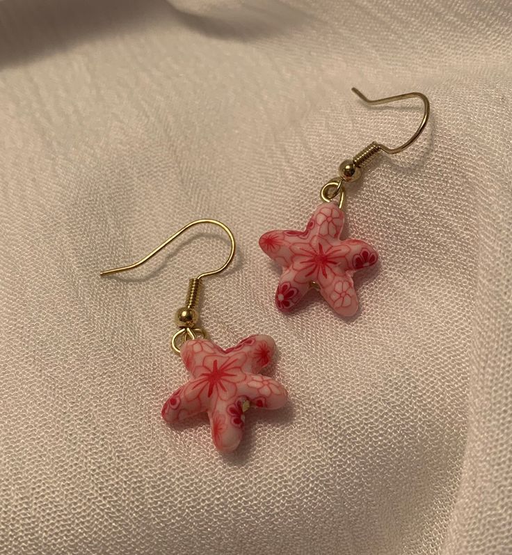 These Dainty, Pink Clay Starfish Drop Earrings are the perfect accessory to complement any outfit. Each pair is handmade and produced in very small quantities, so you're guaranteed to have a unique look.                   ❤ Please note that each earring is not perfeclty identical to its counterpart - our jewelry is made entirely by hand,                        so slight variation does occur.    ------------------------------------------------------------------------------------------------------------------------------------------------------------------------- Caring for your jewelry: ❤ Please handle these earrings with care as they are delicate. Our earrings are made to withstand normal wear, but are vunerable to being damaged if extensive pulling/tugging occurs.  ❤ Avoid getting wet (do Clay Starfish, Easton Md, Starfish Jewelry, Earrings Star, Starfish Earrings, Snowflake Earrings, Pink Clay, Earrings Pink, Silver Shop