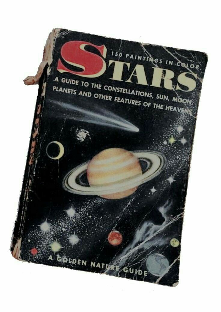 an old book that is sitting on a table with the cover pulled up to look like it's from outer space