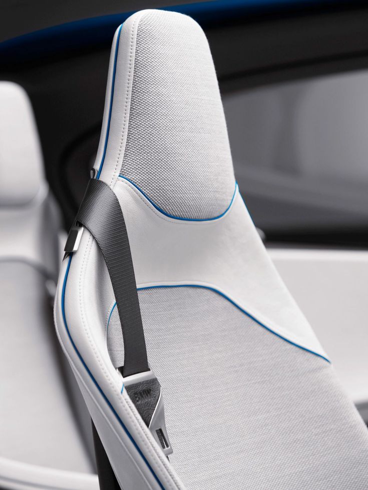 the interior of a car with white and blue trim