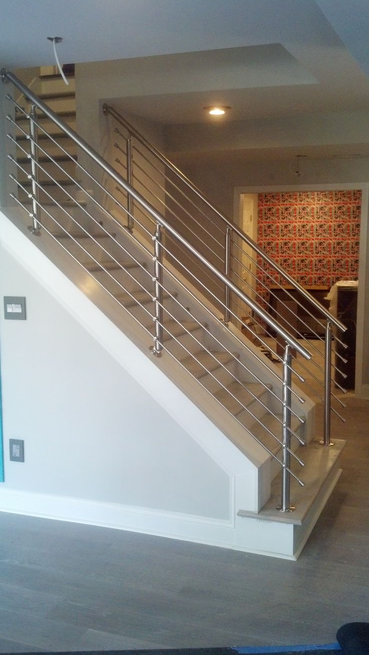 an empty living room with stairs leading up to the second floor