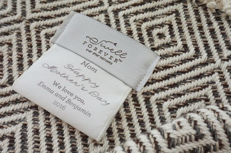 a close up of a label on a woven material with some type of fabric in the background