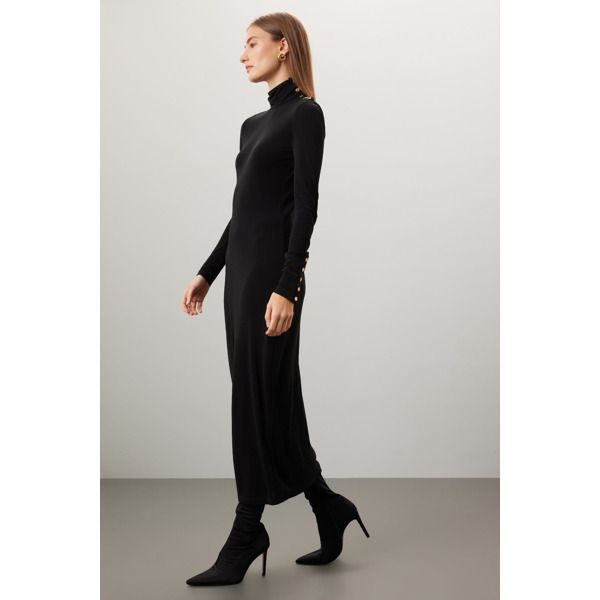 Black knit (100% Viscose). A-line. Long sleeves. Turtleneck. Imported. Fall Evening Viscose Maxi Dress, Viscose Dress For Night Out In Fall, Winter Evening Turtleneck Midi Dress, Turtleneck Midi Dress For Workwear, Chic Fit And Flare Winter Dress, Sleek Turtleneck Dress For Fall, Chic Winter Fit And Flare Dress, Elegant Winter Midi Dress In Viscose, Sleek A-line Dresses For Fall