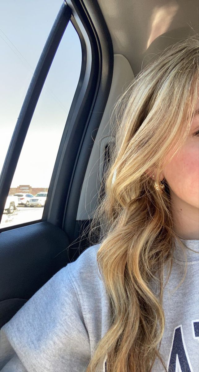 a woman sitting in the back seat of a car